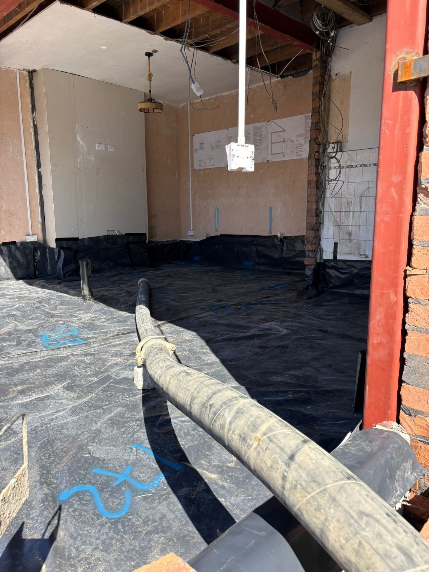 Flowing screed levelled over UFH pipework in a rear extension