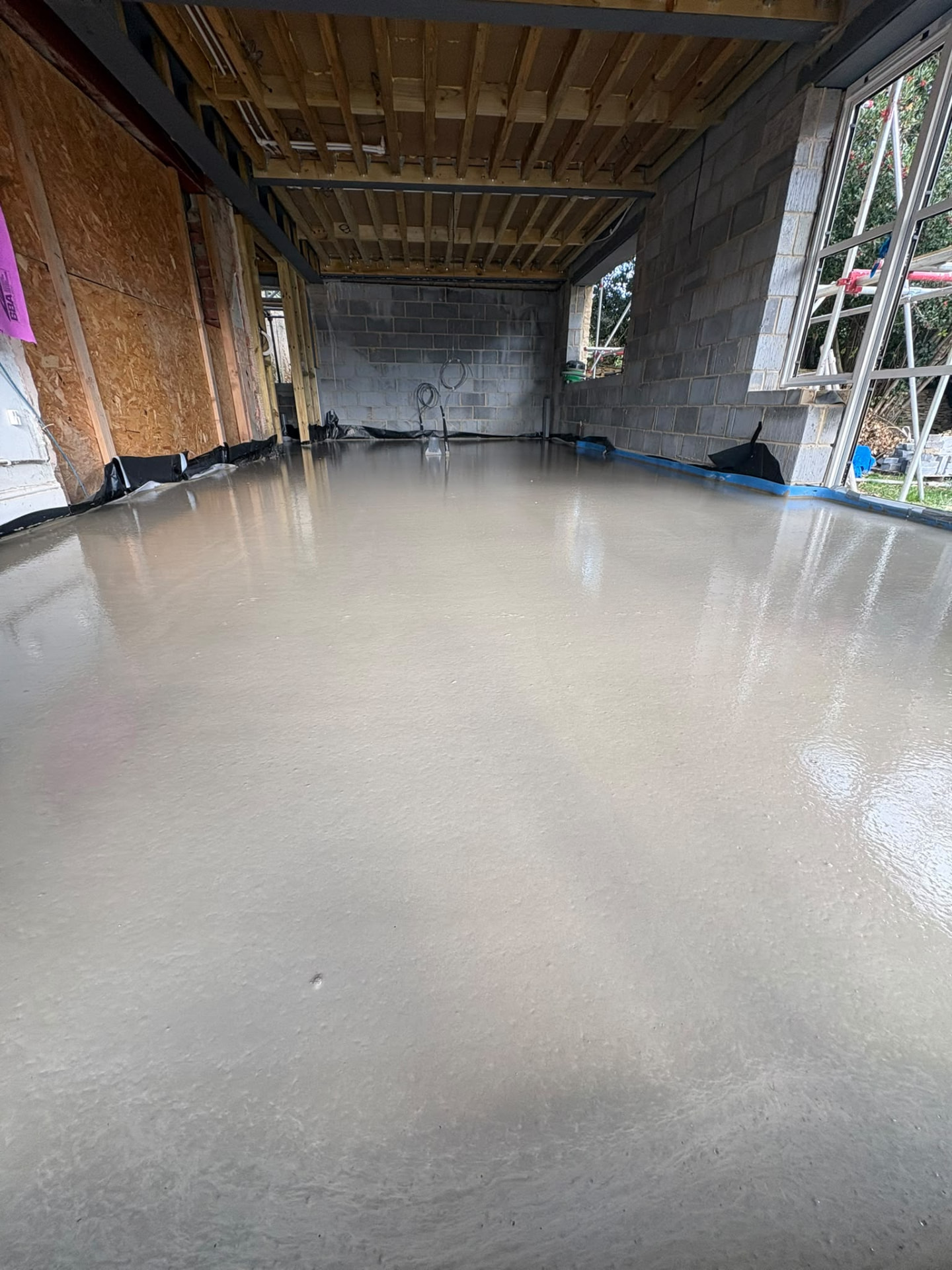 Freshly poured liquid screed in a South Wales extension