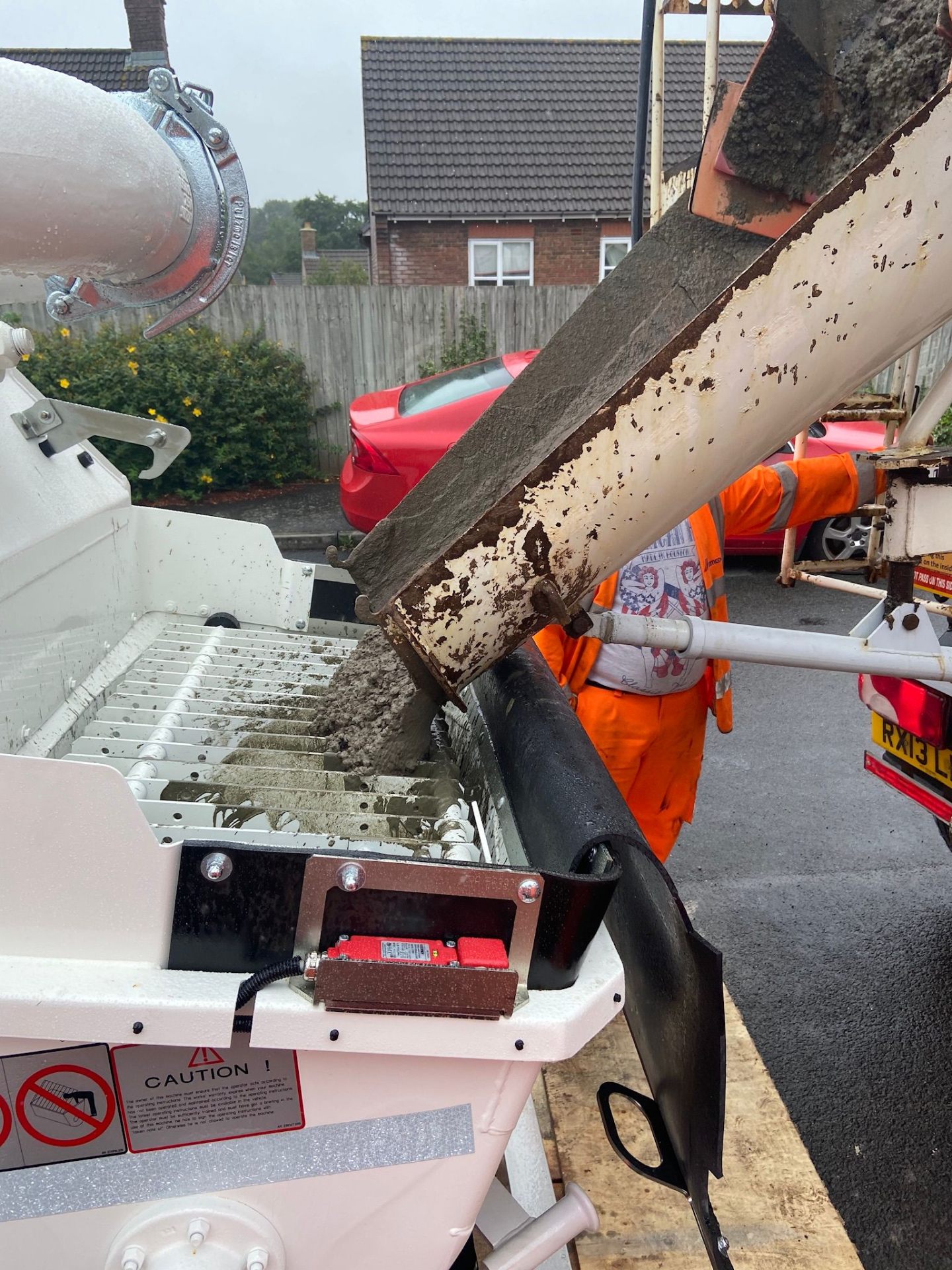 Pumped liquid screed flowing into a South Wales residential ground floor