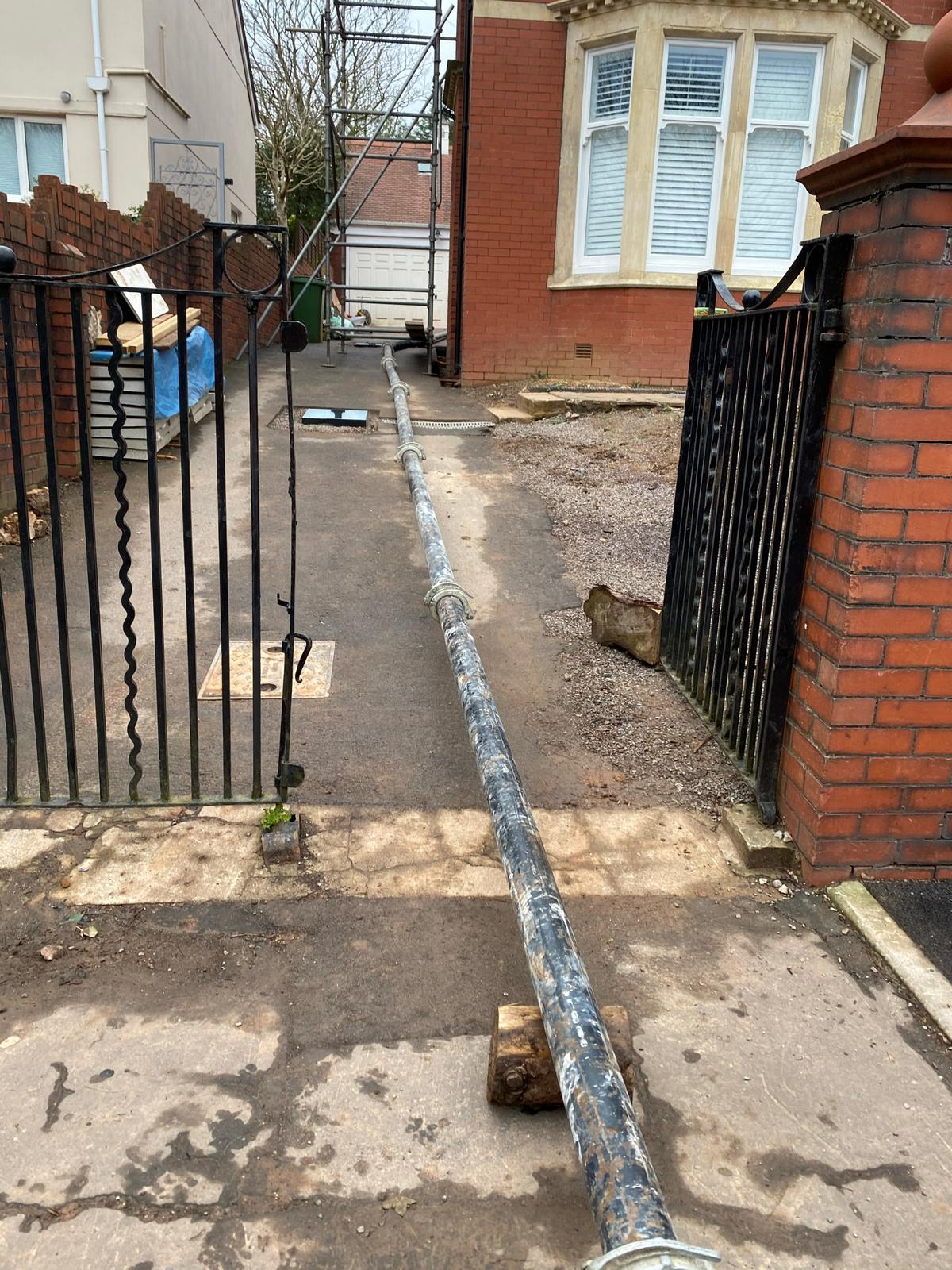 Concrete foundations being placed with rake and pump hose