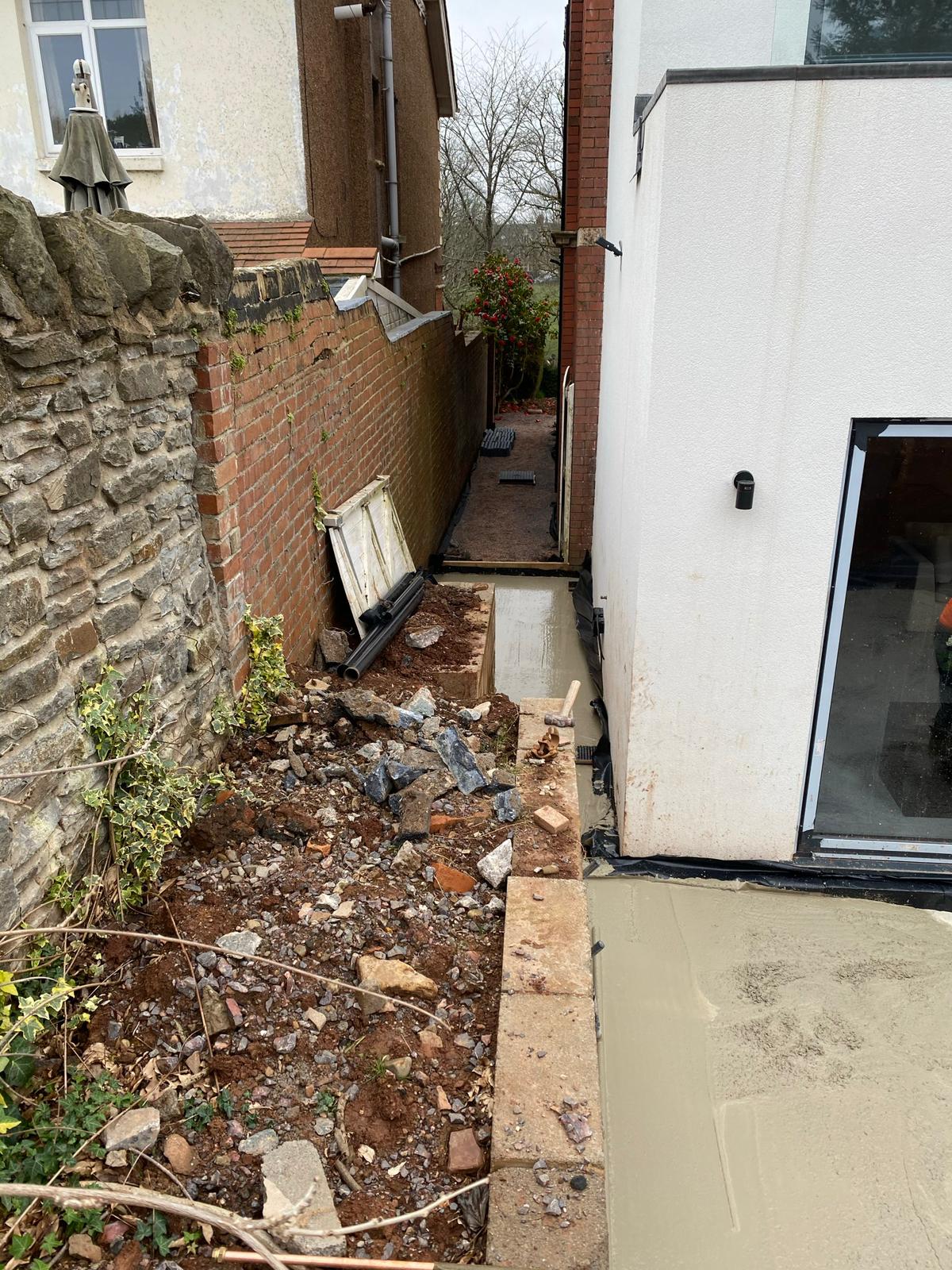 Hose laid across paving and steps reaching a Cardiff back garden