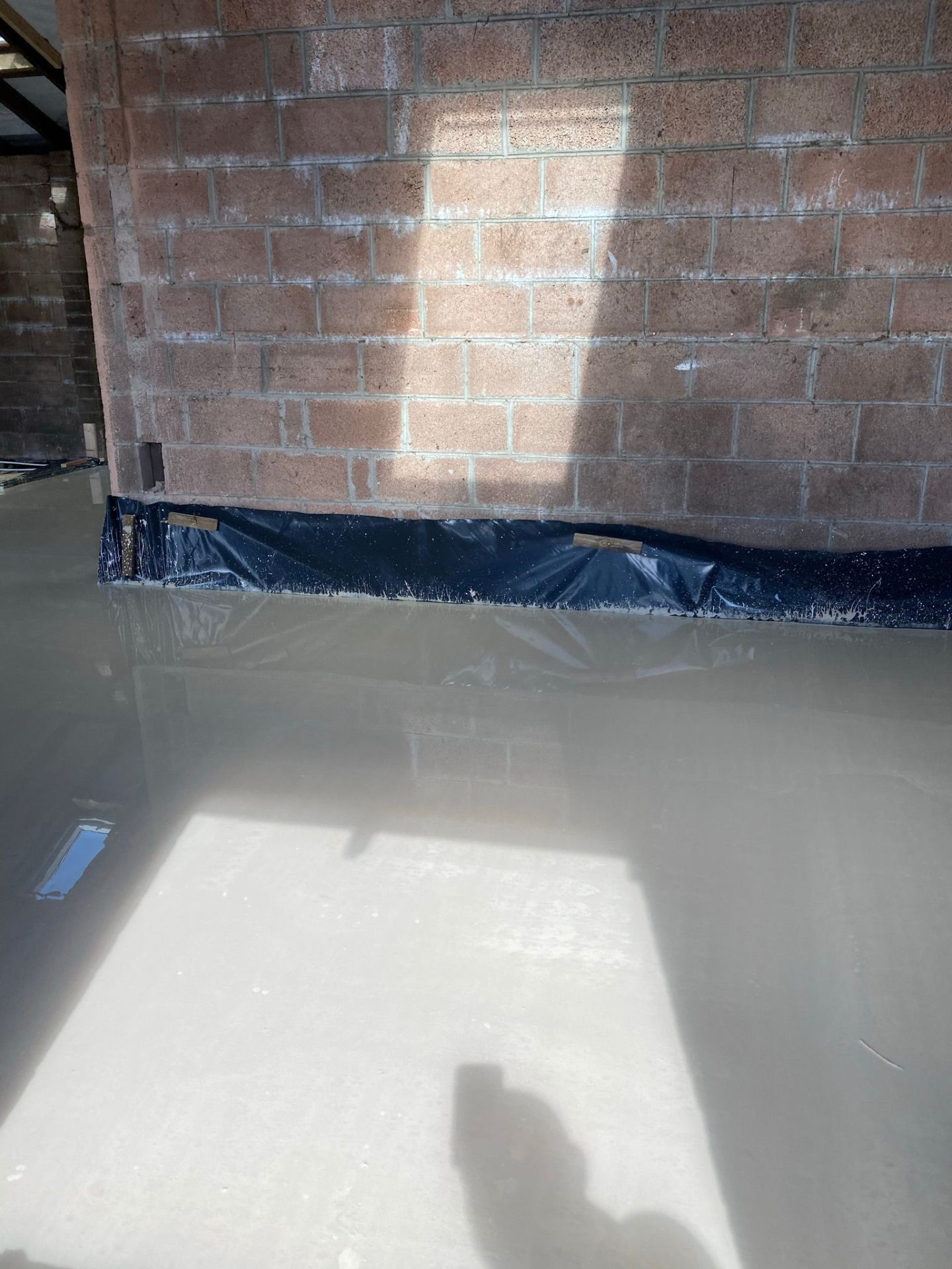 Underfloor heating pipework laid edge to edge in a bedroom