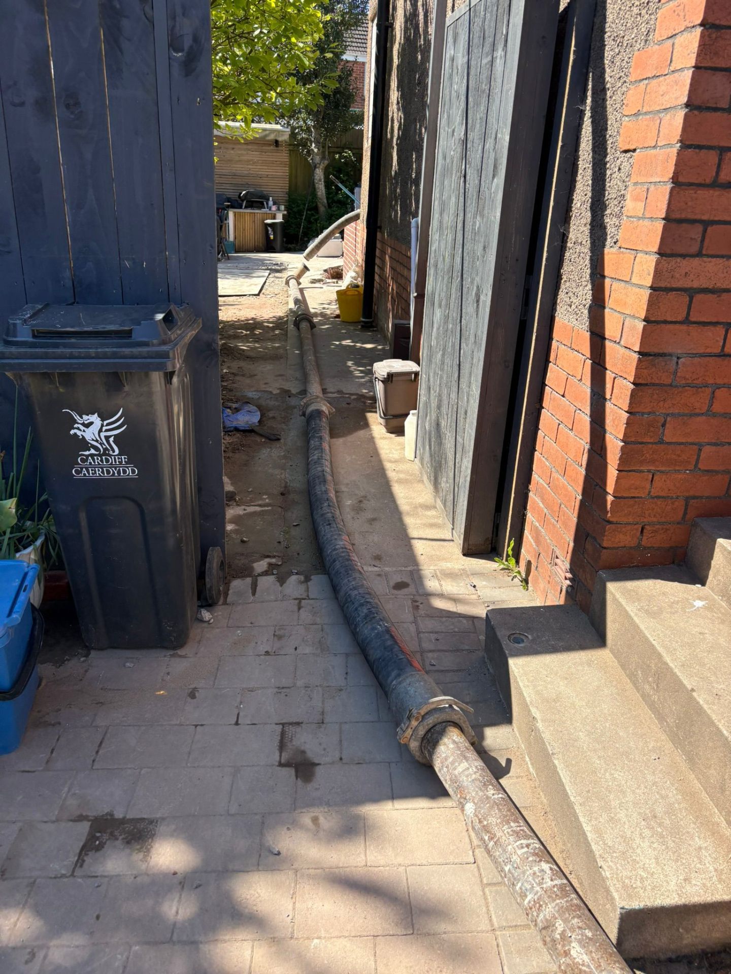 Hose run from pump to property over prepared floor