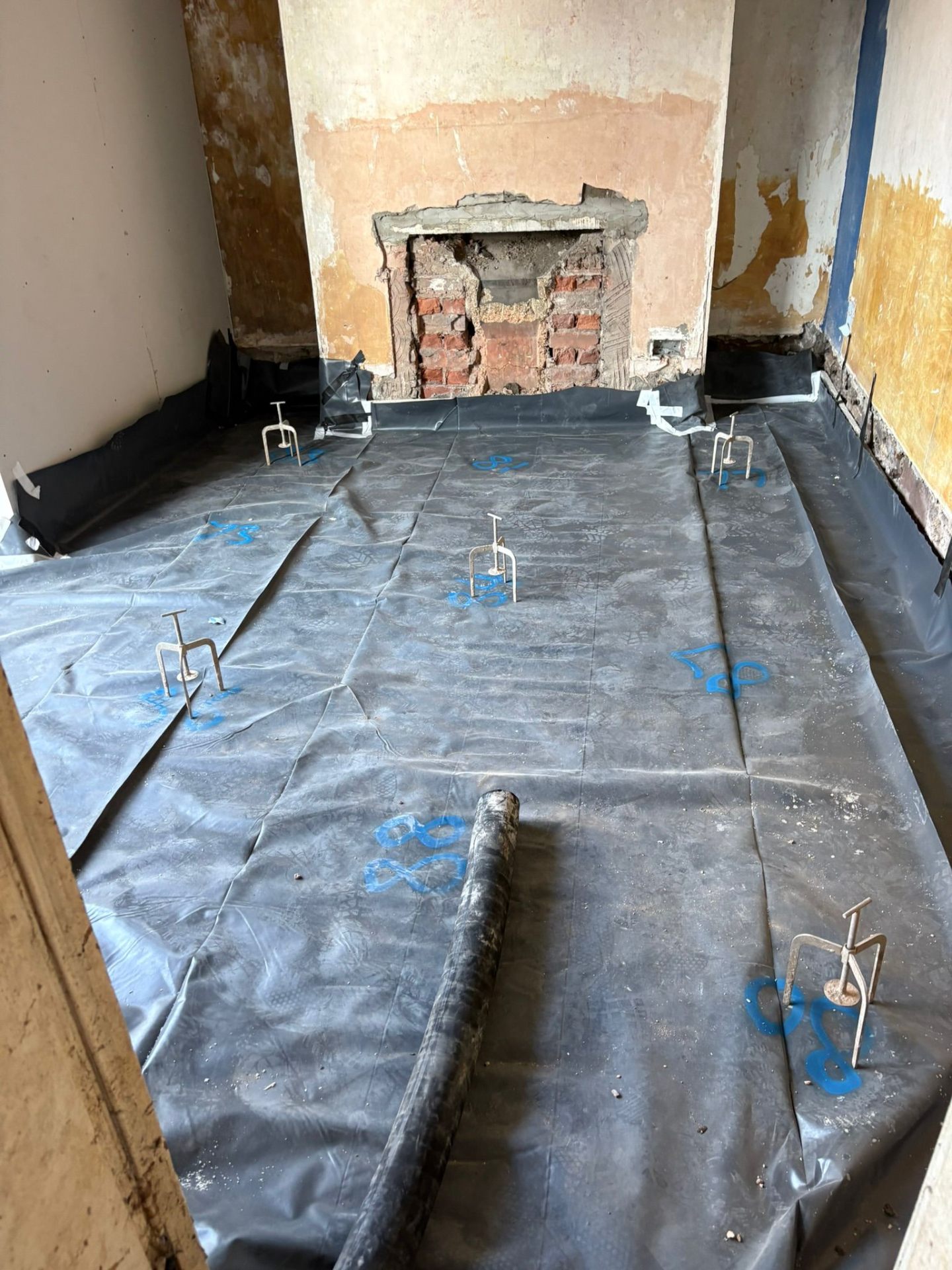 DPM and chairs around a brick chimney breast on a renovation