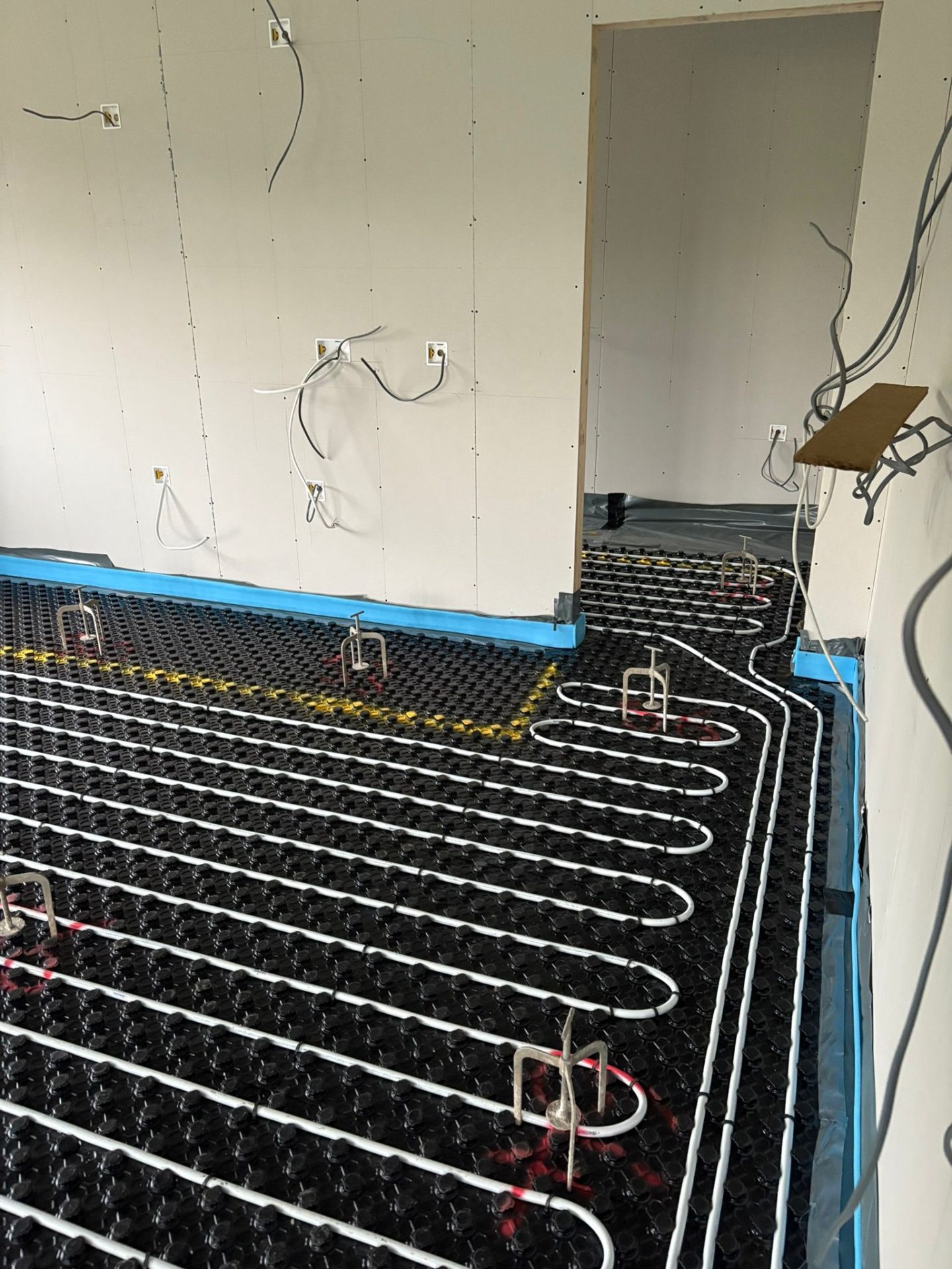 Underfloor heating laid on insulation in a kitchen extension