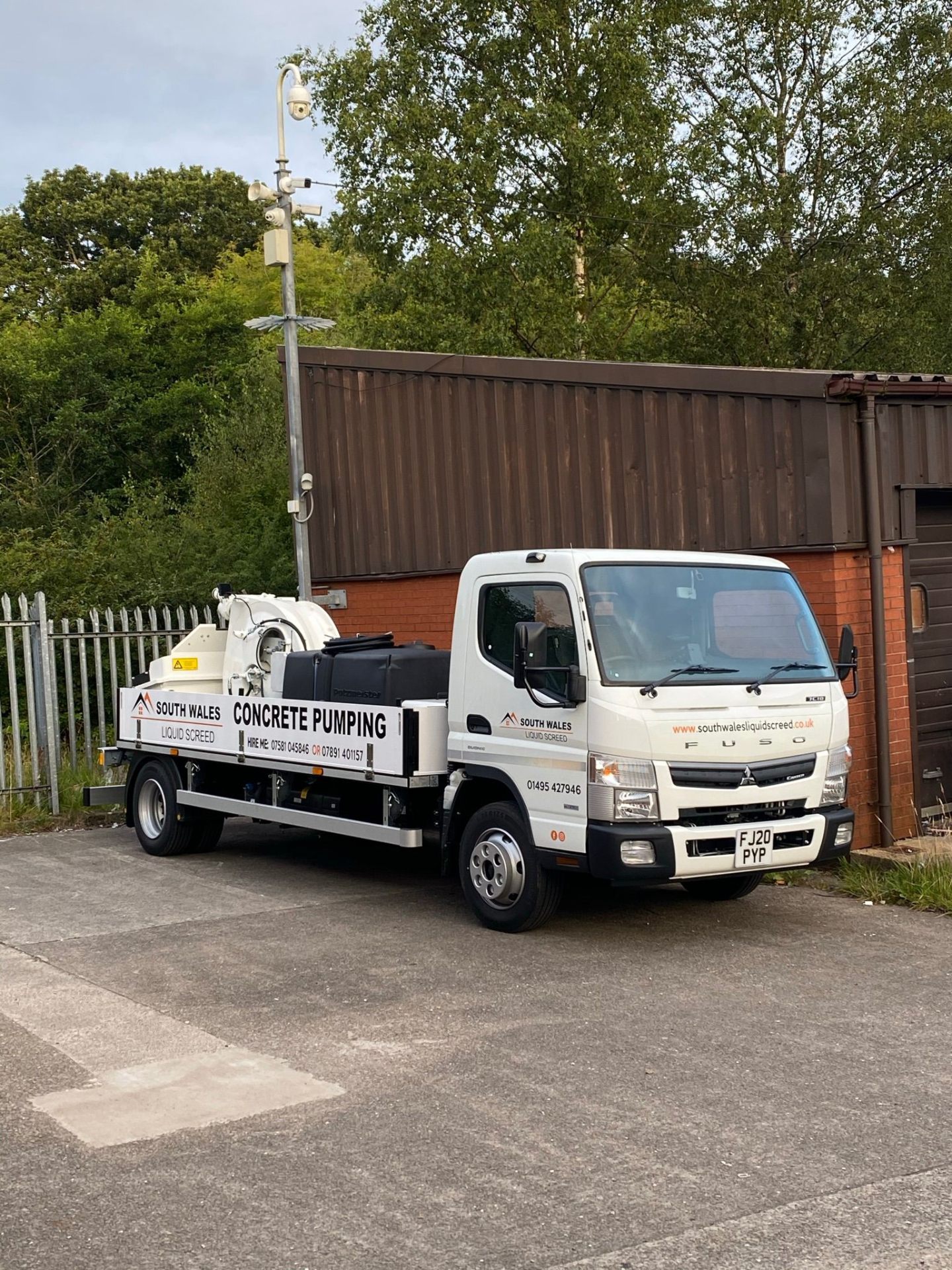 Concrete pump receiver hopper loaded from a ready-mix wagon